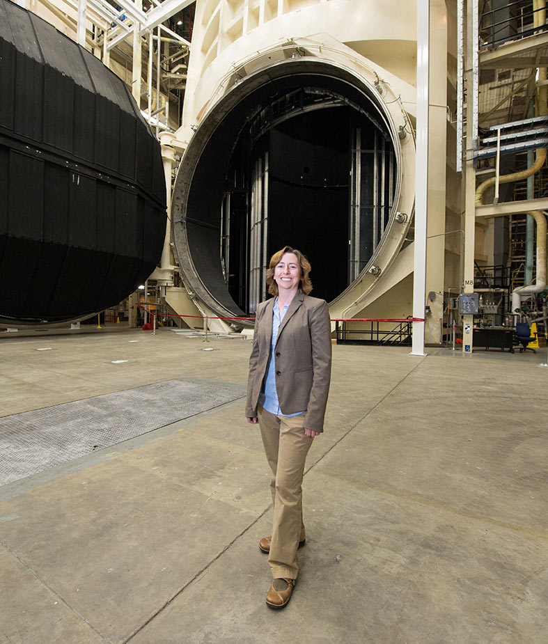 Warren in front of a vacuum chamber at NASA’s Johnson Space Center