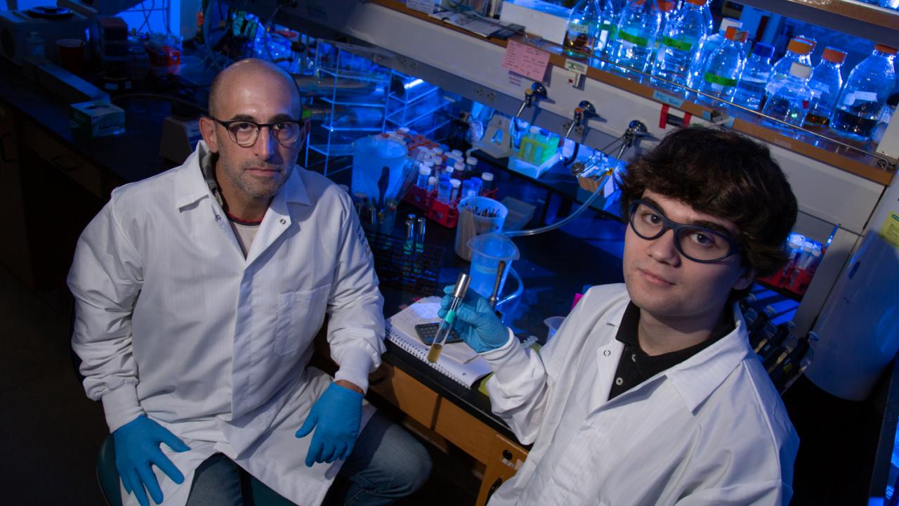 Professor Ken Kaplan and student Mackenzie Noon sit in the lab
