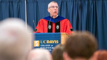 Dean Mark Winey speaking at podium. 