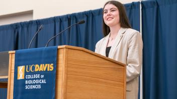 Female student speaking at podium. 