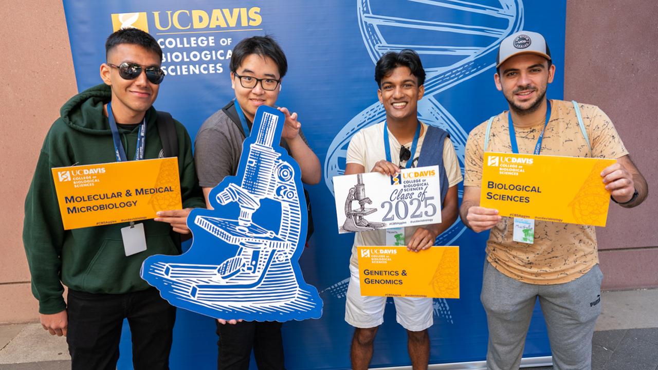 Group of students posing for a photo with CBS signs
