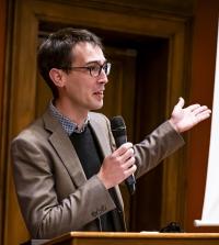 Aurele Piazza speaking at a microphone