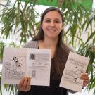 Young Scientist Program founder Briana Rocha-Gregg displays the group's new activity book Exciting Science by Cool Scientists!, a primer on model organisms. David Slipher/UC Davis 