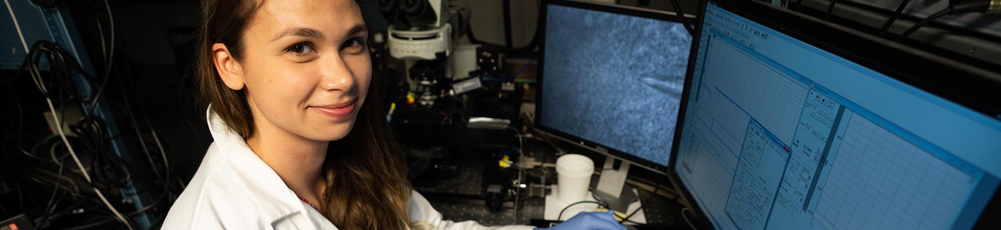 Female researcher sitting in front of computer monitor
